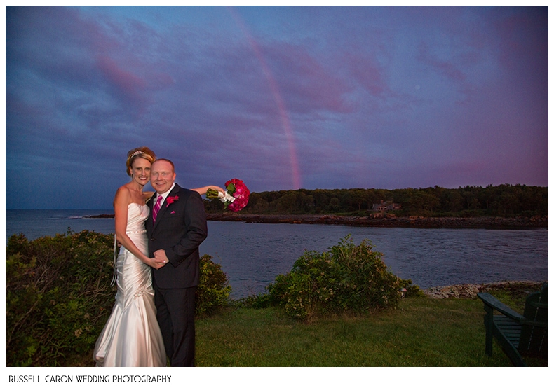 Bride and groom with a rainbow on their wedding day