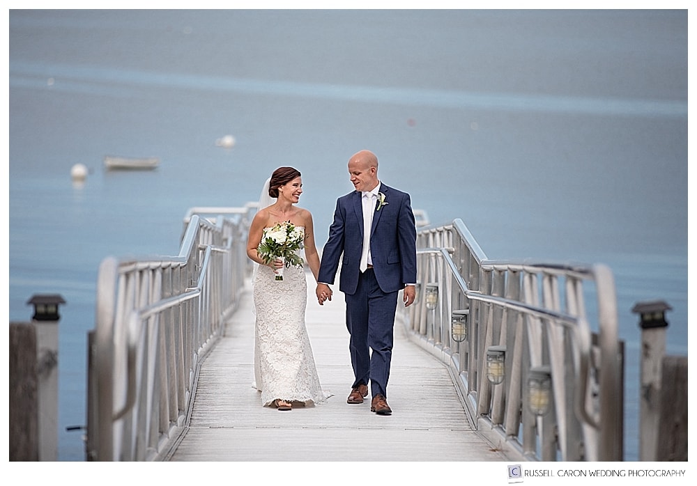 bride and groom walking on the dock at their Atlantic Oceanside Bar Harbor wedding, Bar Harbor, Maine