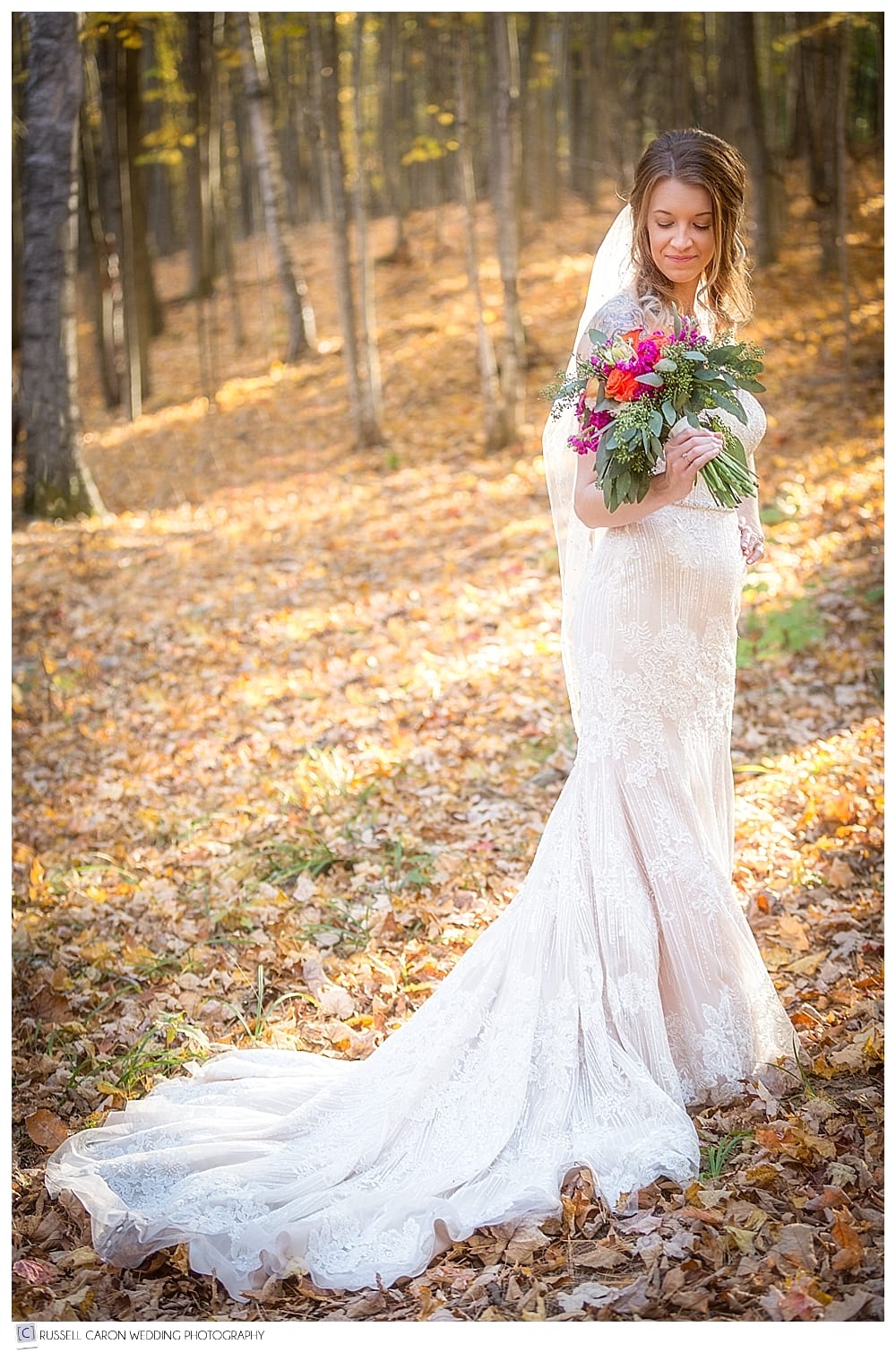 full length photo of a bride in the autumn woods