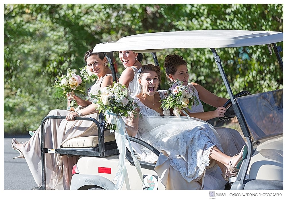 Bride and bridesmaids laughing in a golf cart on Peaks Island Maine