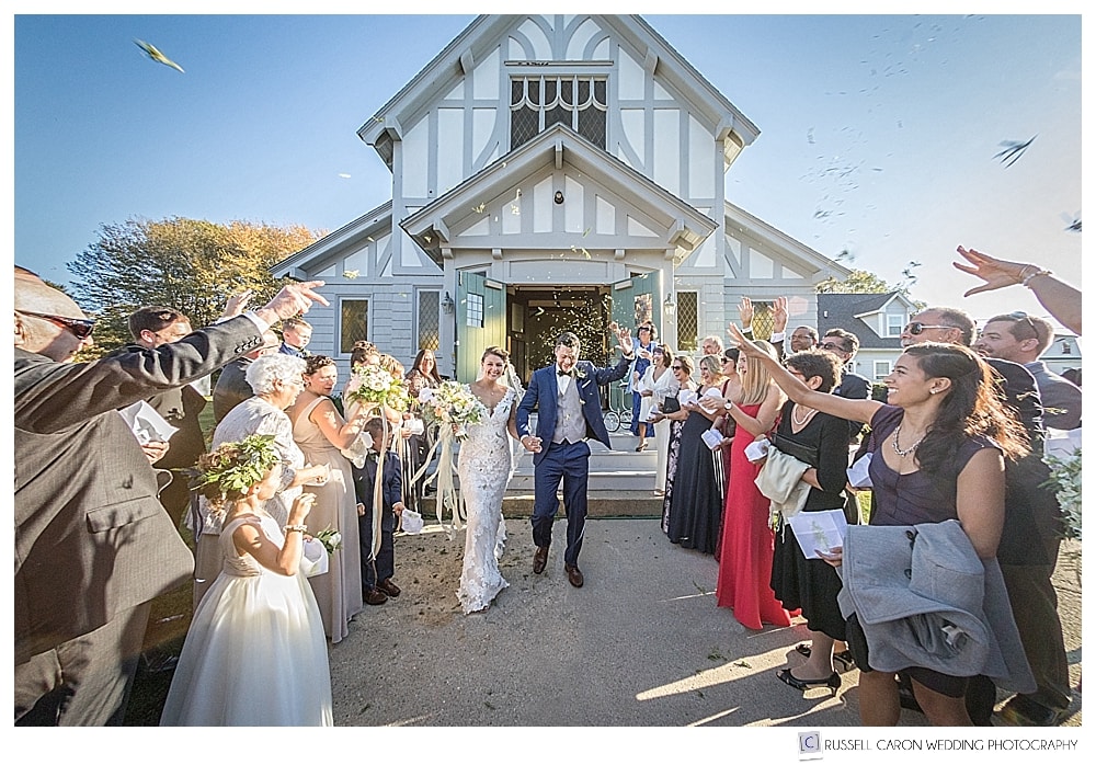 Bride and groom during wedding recessional at St. Christopher Parish at their Peaks Island Maine wedding