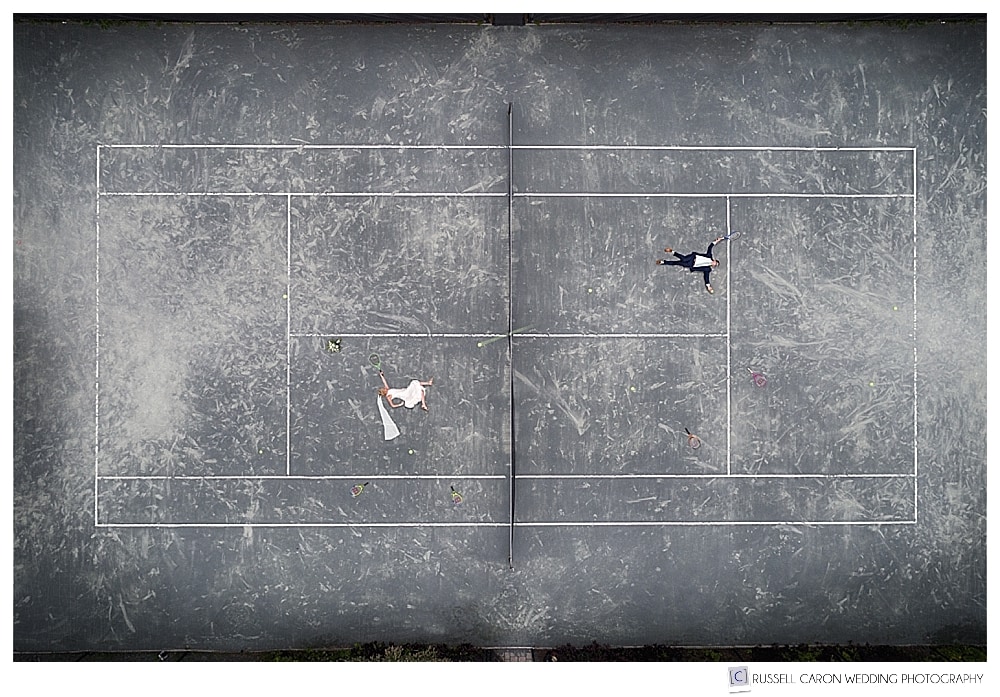 Maine drone wedding photo of a bride and groom on a tennis court.