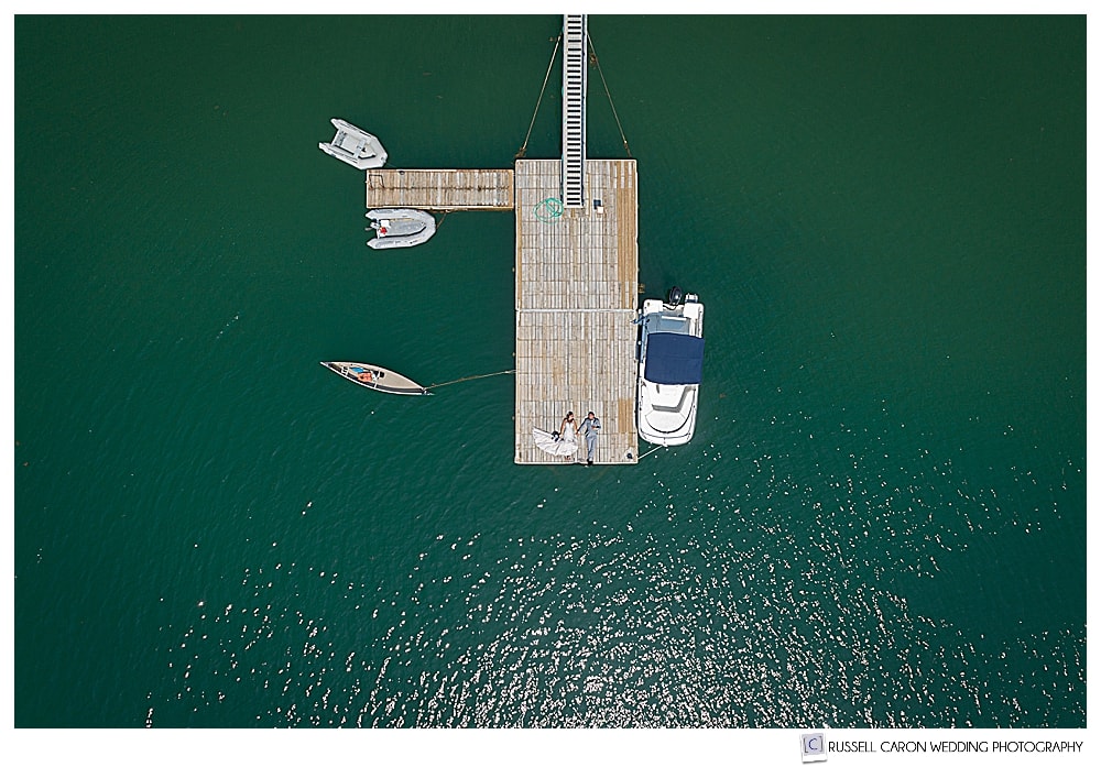 A bride and groom on a dock in a Bar Harbor Maine Drone wedding photo