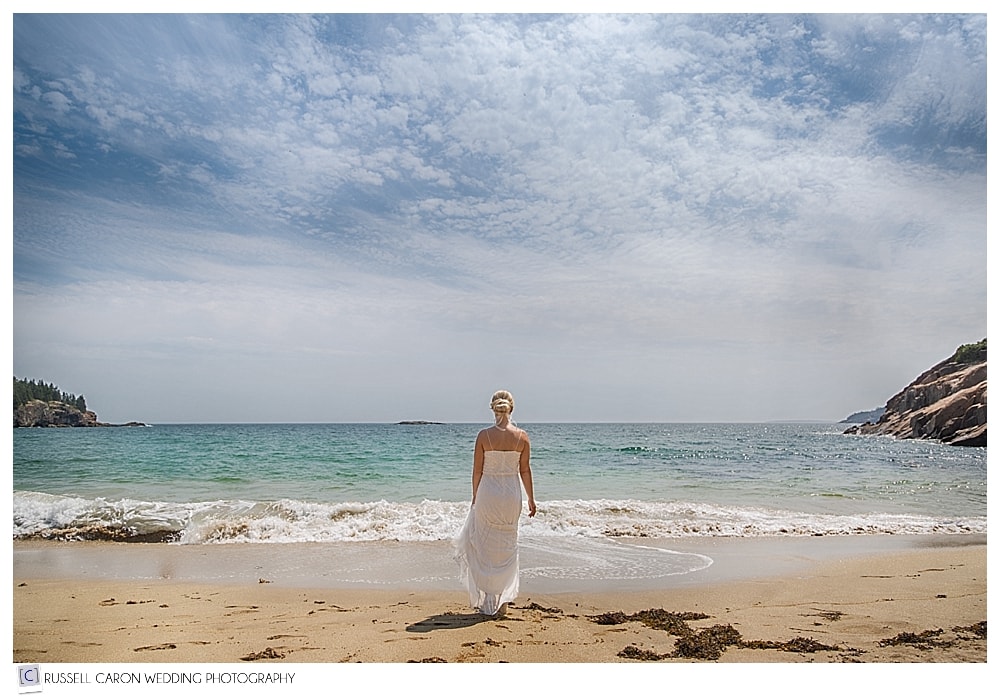 bride walking toward ocean at sand beach acadia national park wedding photos