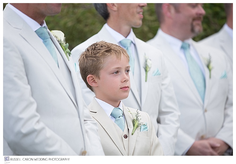 junior groomsman during wedding ceremony