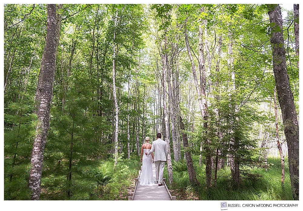 bride and groom walking on a trail in Acadia National Park, moments before their Bar Harbor Maine wedding