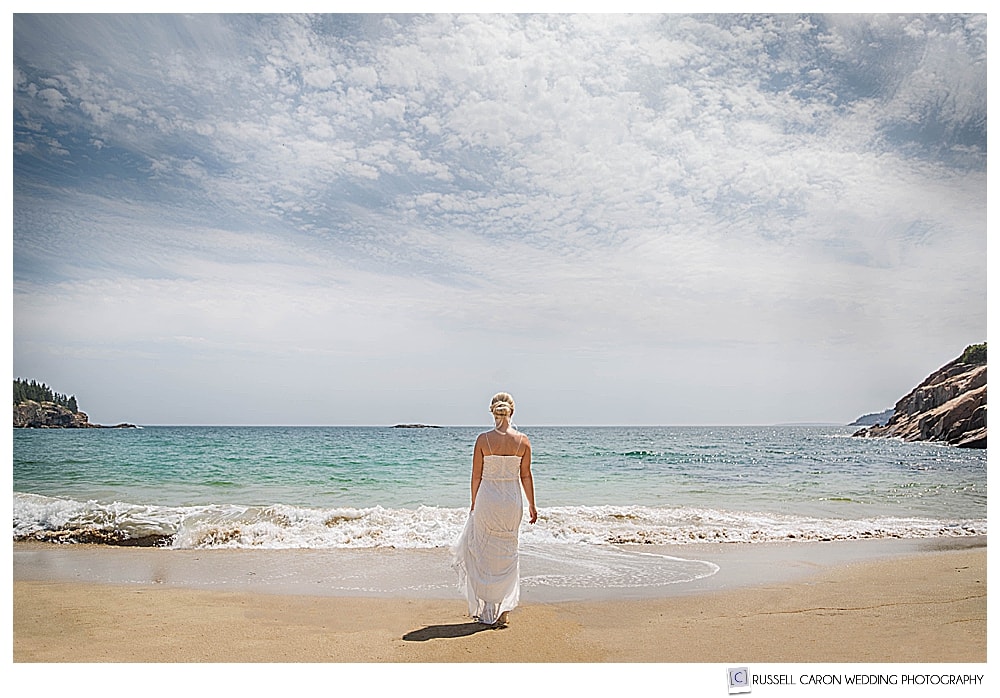 bride walking toward the water at Sand Beach, Acadia National Park, Bar Harbor, Maine