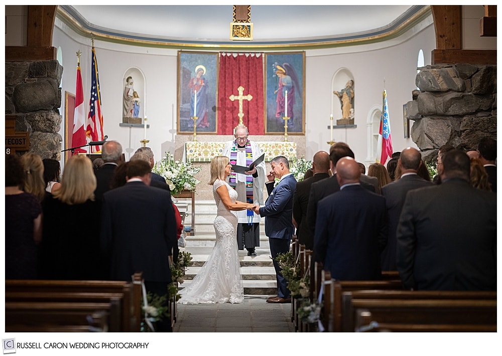 bride and groom stand at the altar of Saint Ann's Episcopal Church, Kennebunkport, Maine