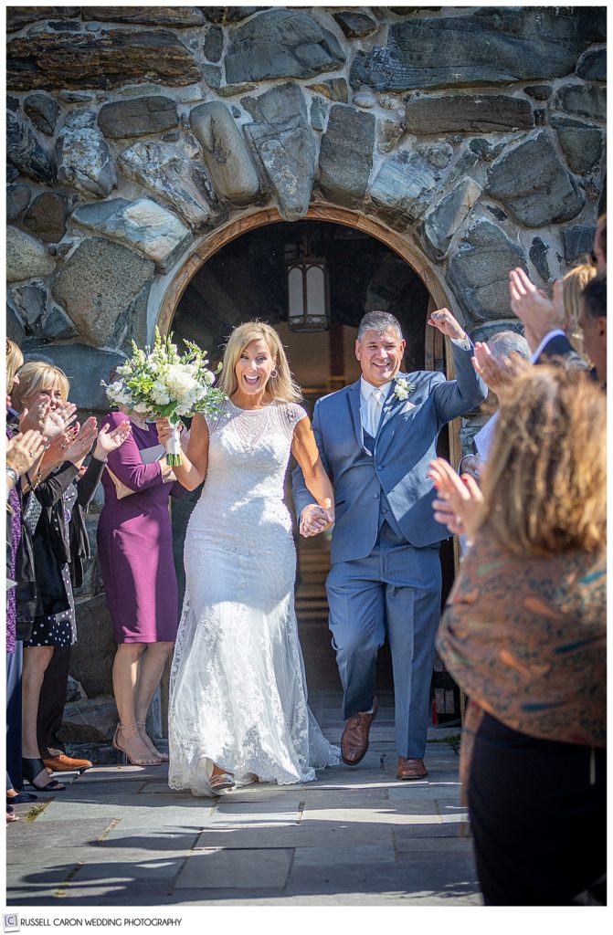 bride and groom coming out of Saint Ann's Episcopal Church during their Kennebunkport, Maine, wedding recessional