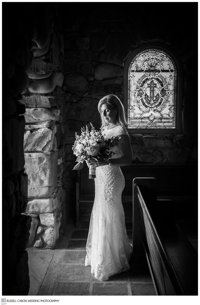 black and white photo of a bride standing in the doorway of Saint Ann's Episcopal Church in Kennebunkport, Maine