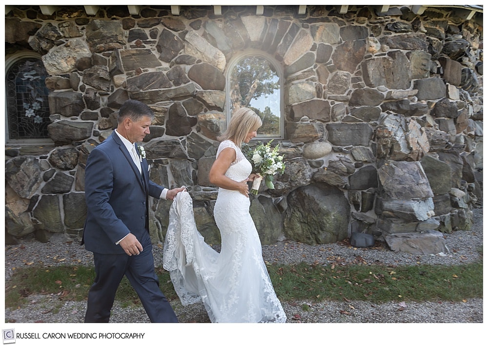 bride and groom walking past Saint Ann's Episcopal Church in Kennebunkport, Maine