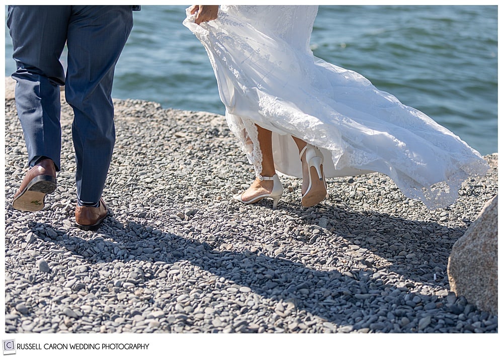 feet of a bride and groom walking on the Kennebunkport, Maine, breakewater