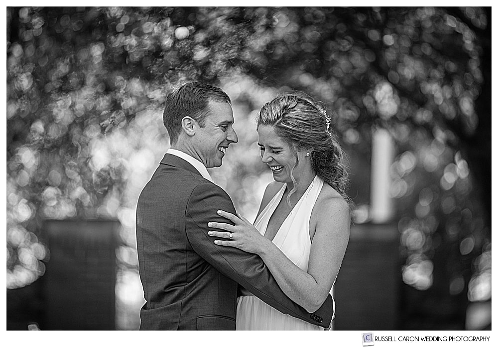 a bride and groom laughing, an example of candid wedding moments  that we try to capture for all couples