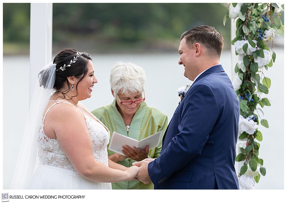 bride and groom holding hands during their wedding ceremony