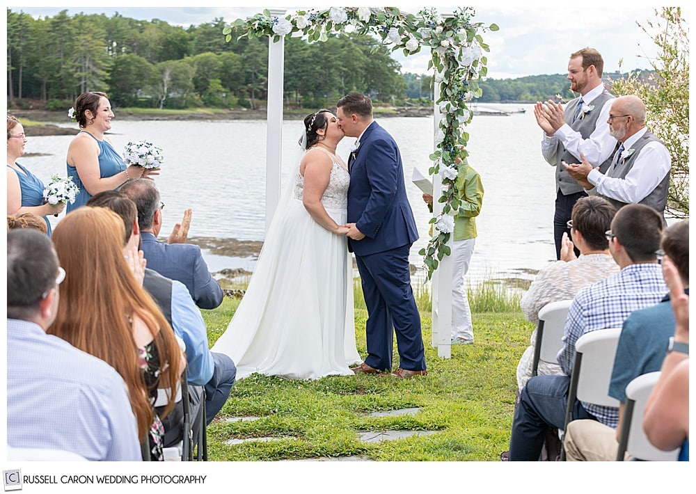 bride and groom's first kiss at their Edgecomb Maine wedding