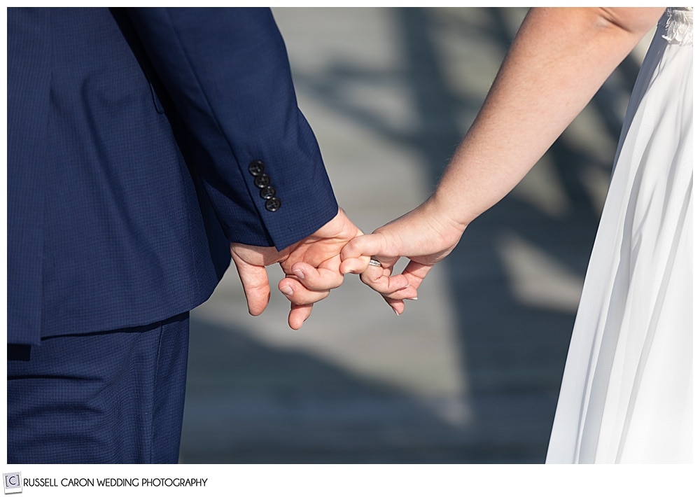 two people holding each other's pinkies