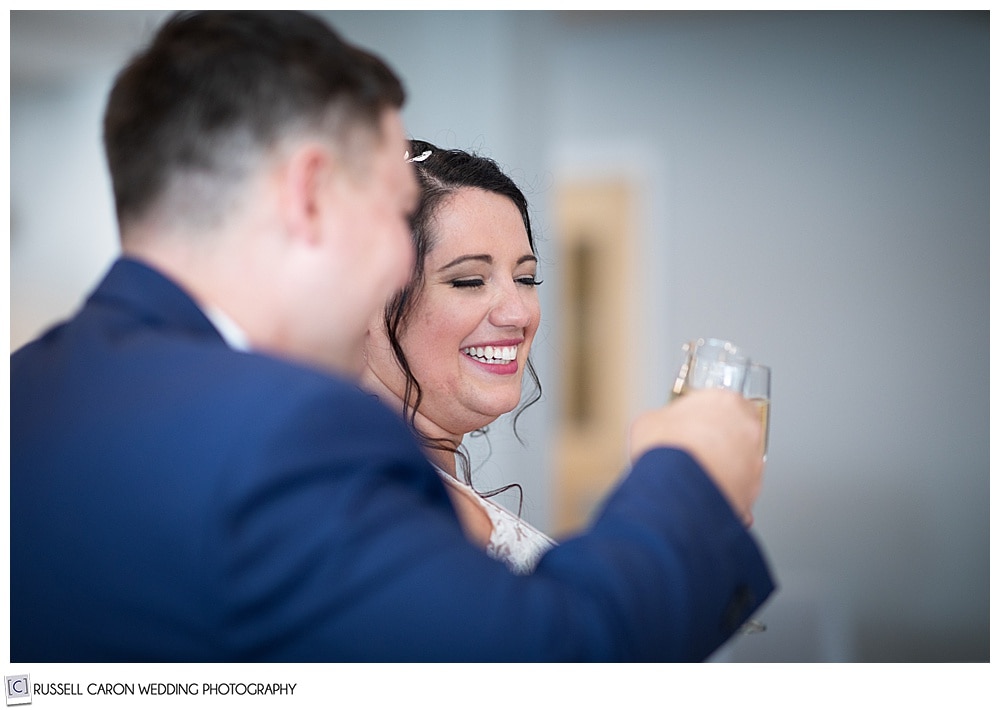 side view of bride and groom toasting