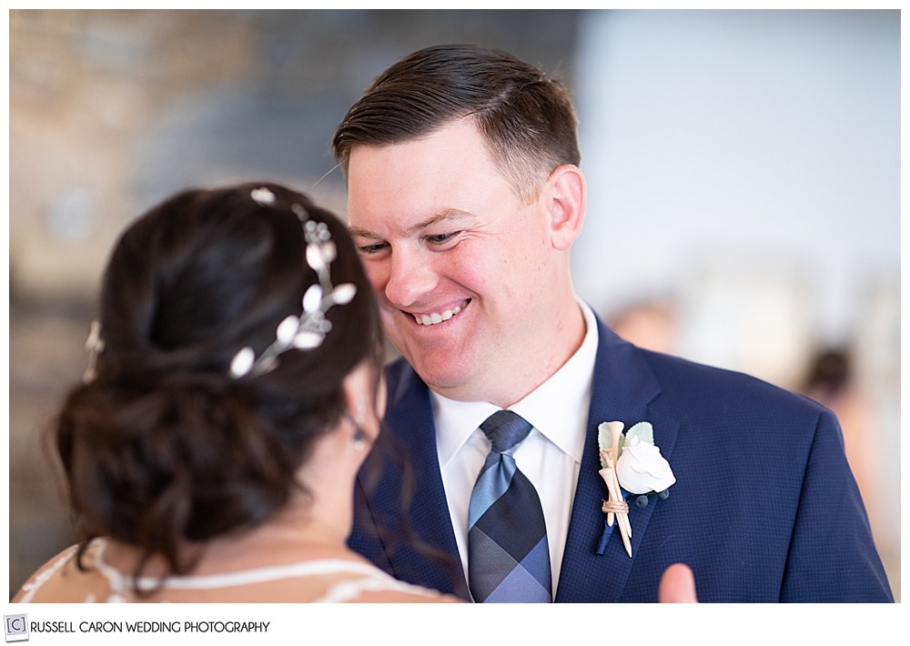 groom smiling at bride during their first dance at their Edgecomb Maine wedding reception