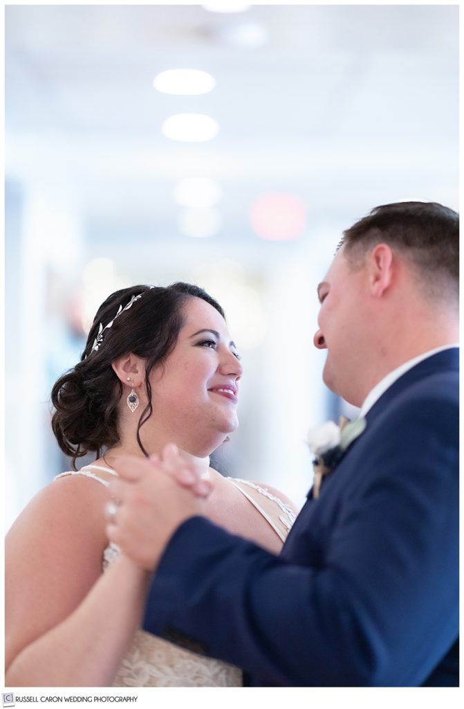 bride smiling at groom during their first dance