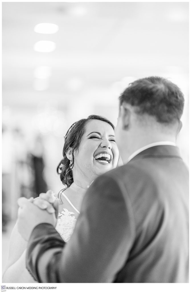 black and white photos of bride laughing with groom during first dance