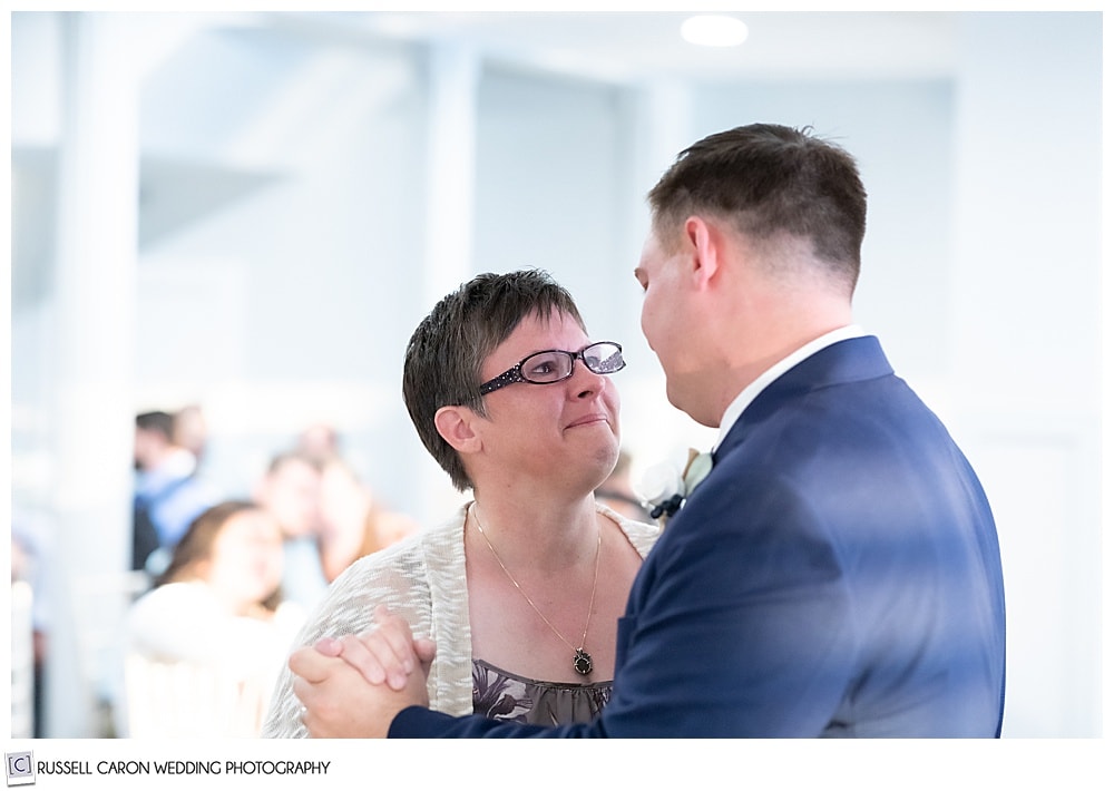 mother of the groom looking at him during their mother son dance