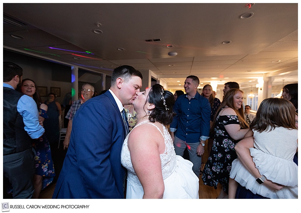 bride and groom kissing on the dance floor