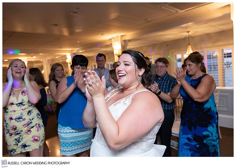 bride clapping her hands during her Sheepscot Harbour Village Resort wedding reception