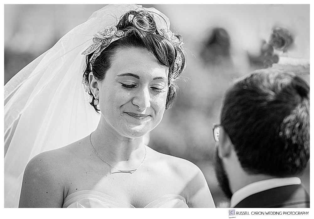 Black and white photo of bride with a tear running down her cheek during her heartfelt Sebasco wedding ceremony
