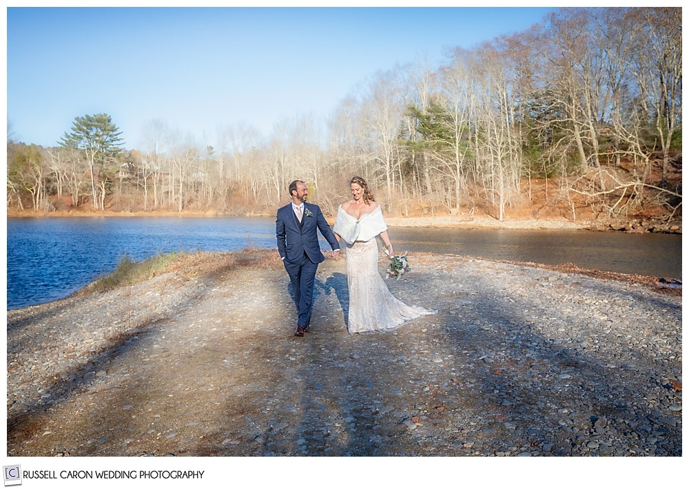 bride and groom holding hands and walking 