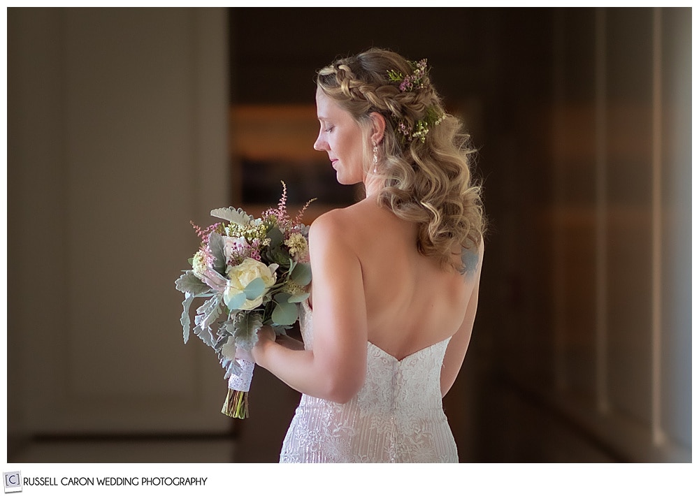 portrait of a bride with her back to the camera, facing her left