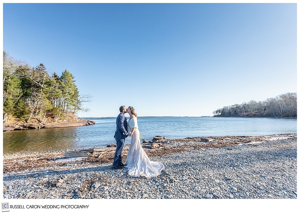 bride and groom kissing on a beach in Maine