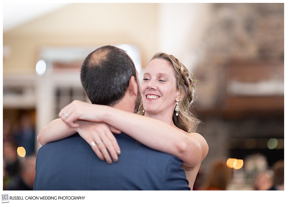 bride smiling at her groom during their first dance at their midcoast maine wedding reception