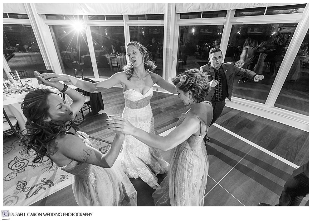 bride and bridesmaids dancing at point lookout midcoast maine wedding