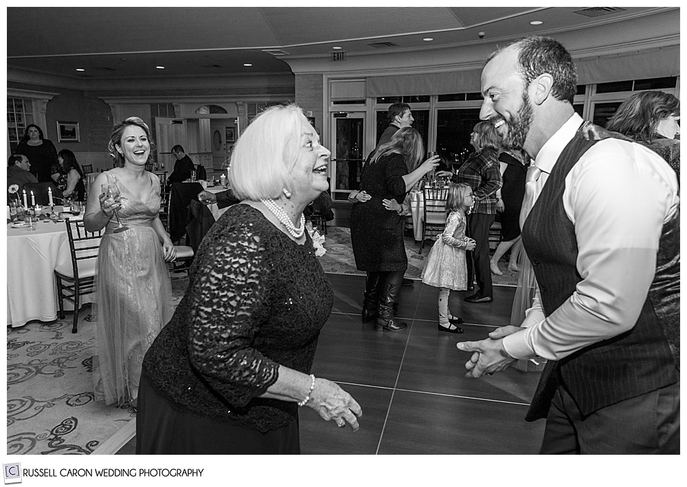 black and white photo of groom and his mother dancing