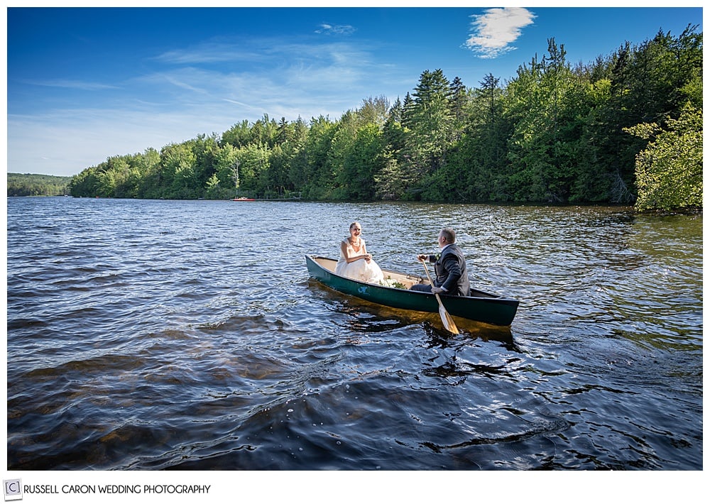 bride and groom in a canoe, with rough water, and blue skies