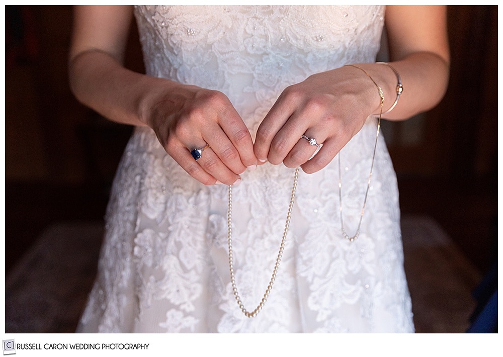 bride holding a string of pearls