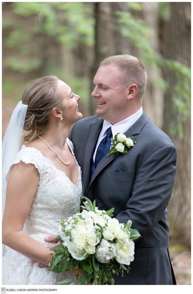 bride and groom looking at each other and smiling