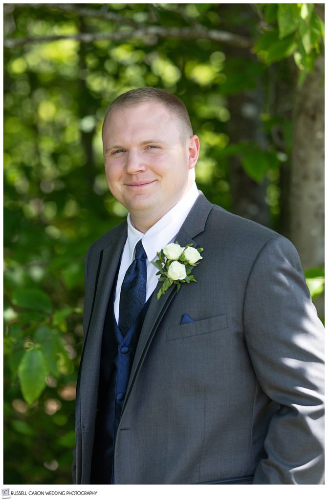 portrait of a groom wearing a dark gray suit 