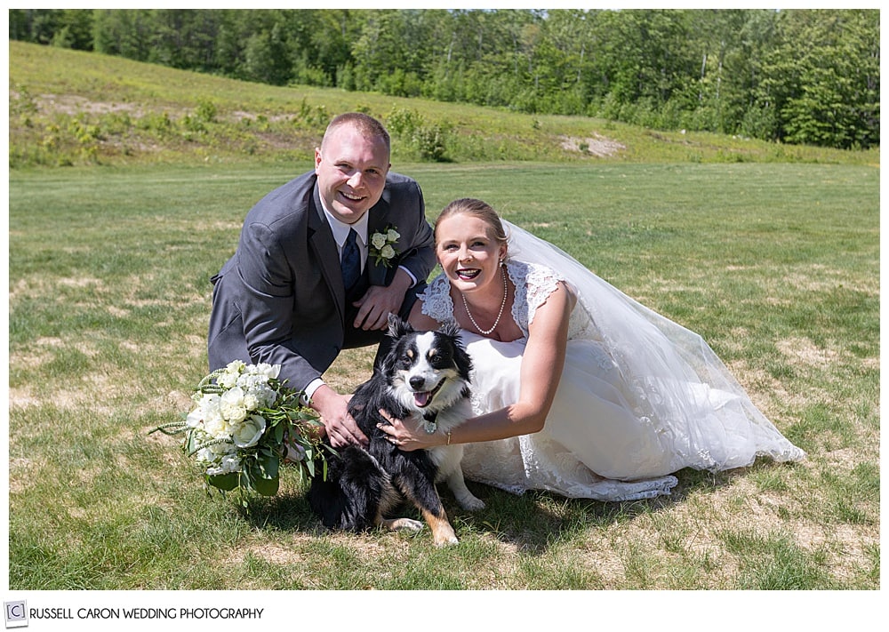 ride and groom crouched down near their dog