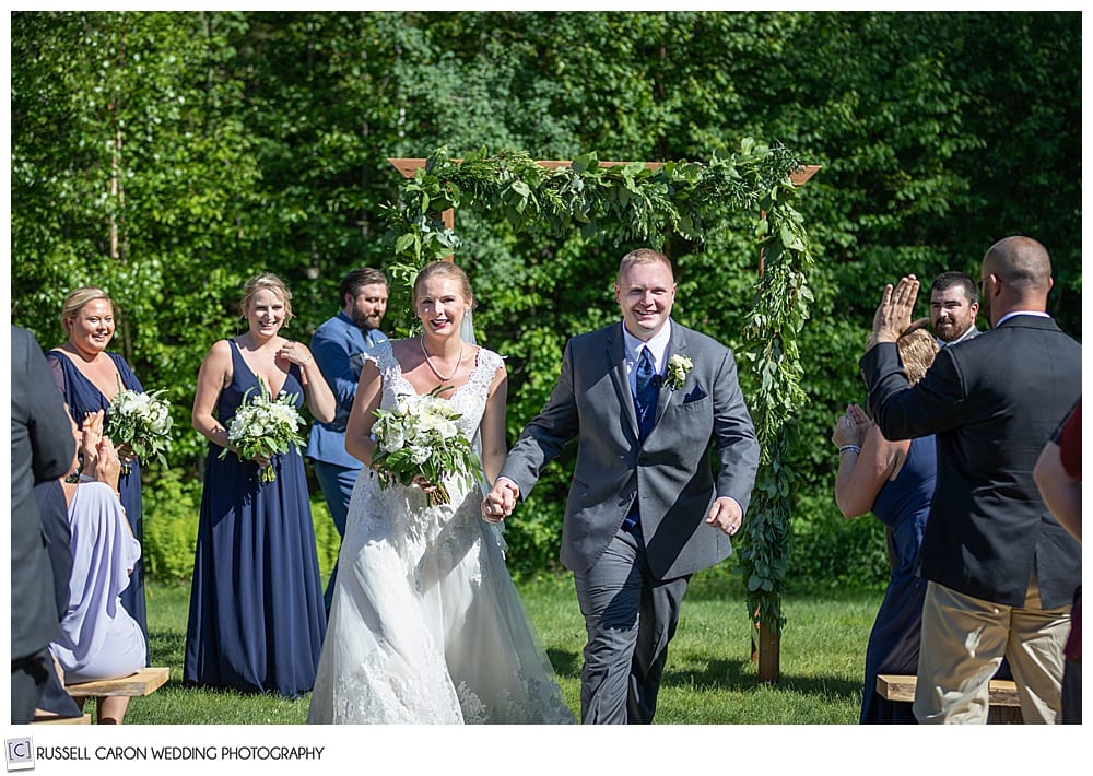 bride and groom during their recessional at Moose Lake Ranch