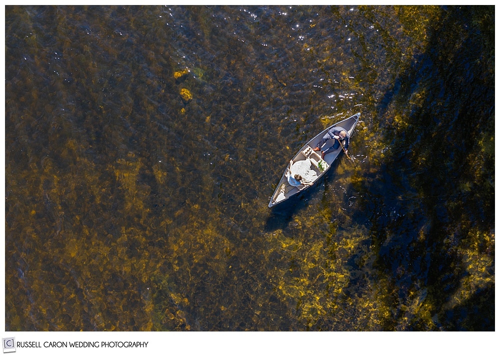 wedding drone photo of a bride and groom in a canoe on a lake