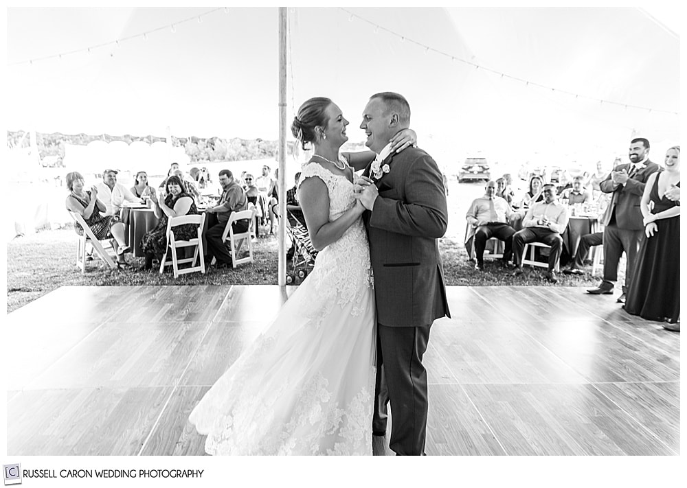 black and white photo of a bride and groom slow dancing 