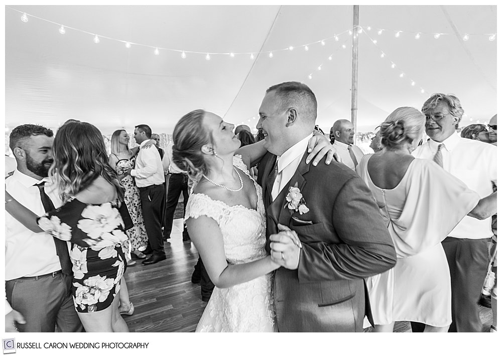 black and white photo of bride and groom dancing