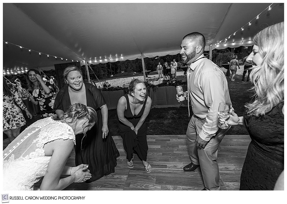 black and white photo of people laughing and dancing