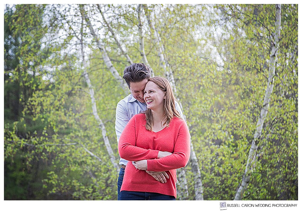 Man hugging woman from behind in Mowfield Farm engagement photo