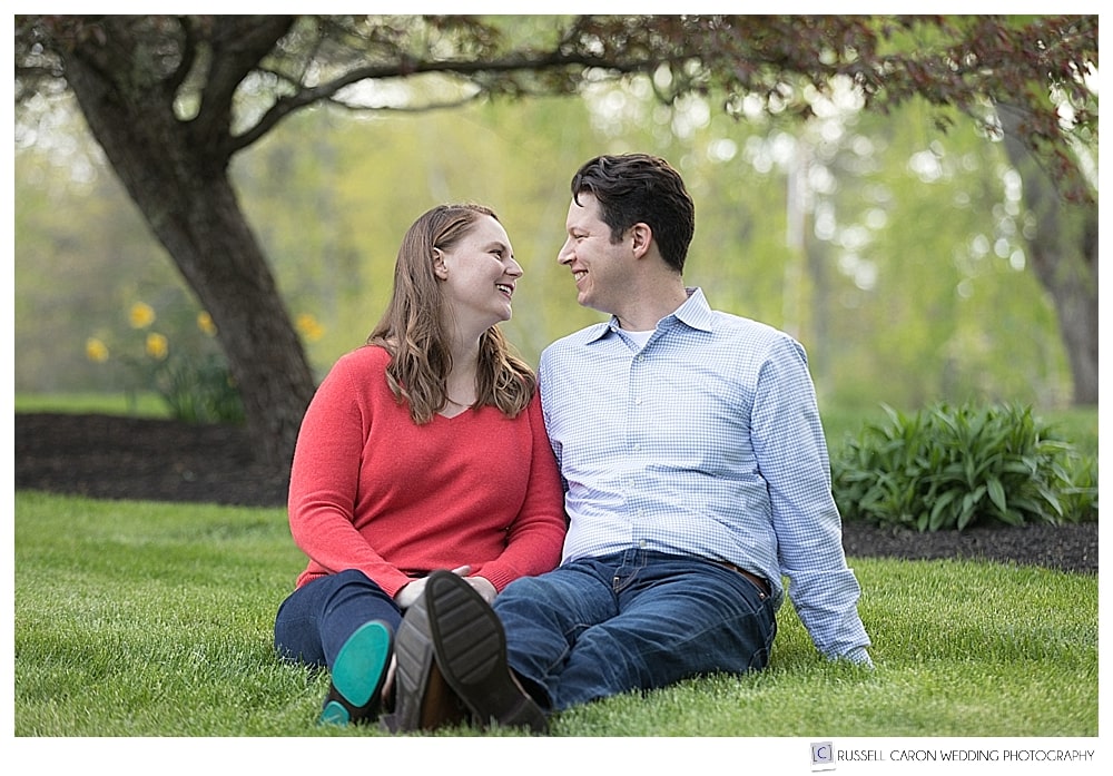 man and woman sitting on the ground during their Mowfield Farm engagement session