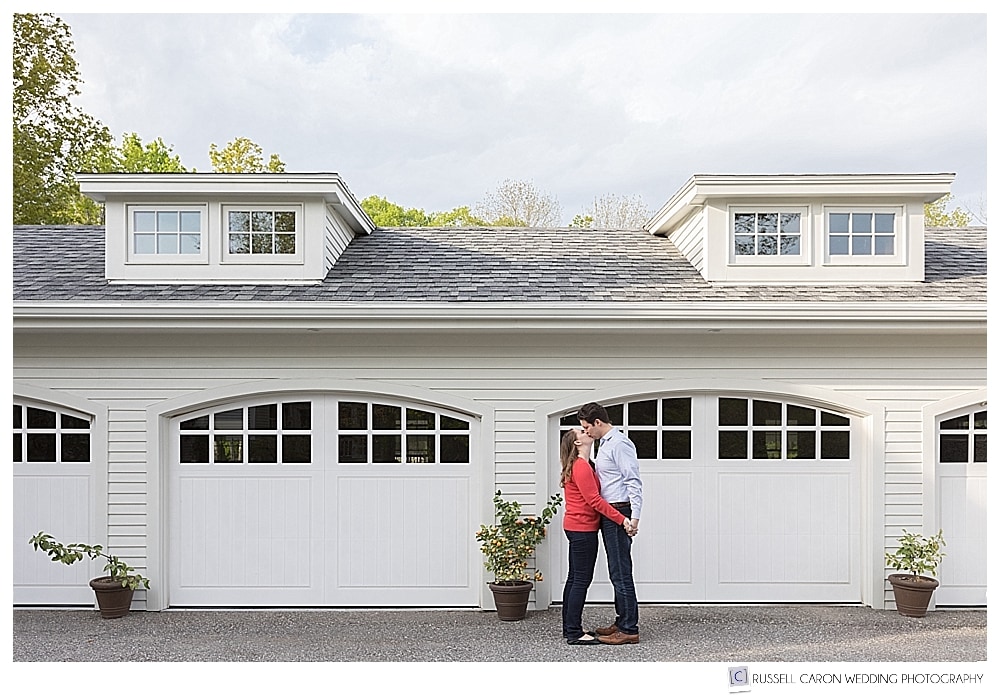 couple kissing in front of a garage at Mowfield Farm engagement