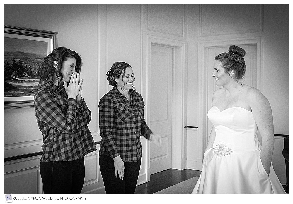 bridesmaids reacting to bride in wedding dress