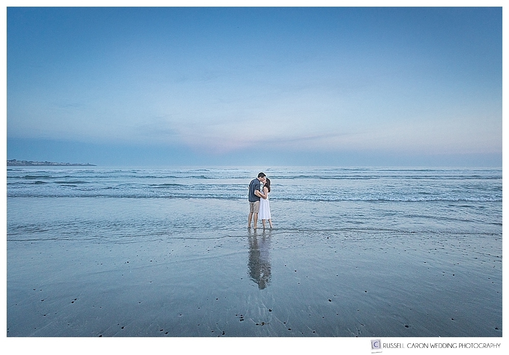 couple kissing in the water at long sands beach in york harbor maine