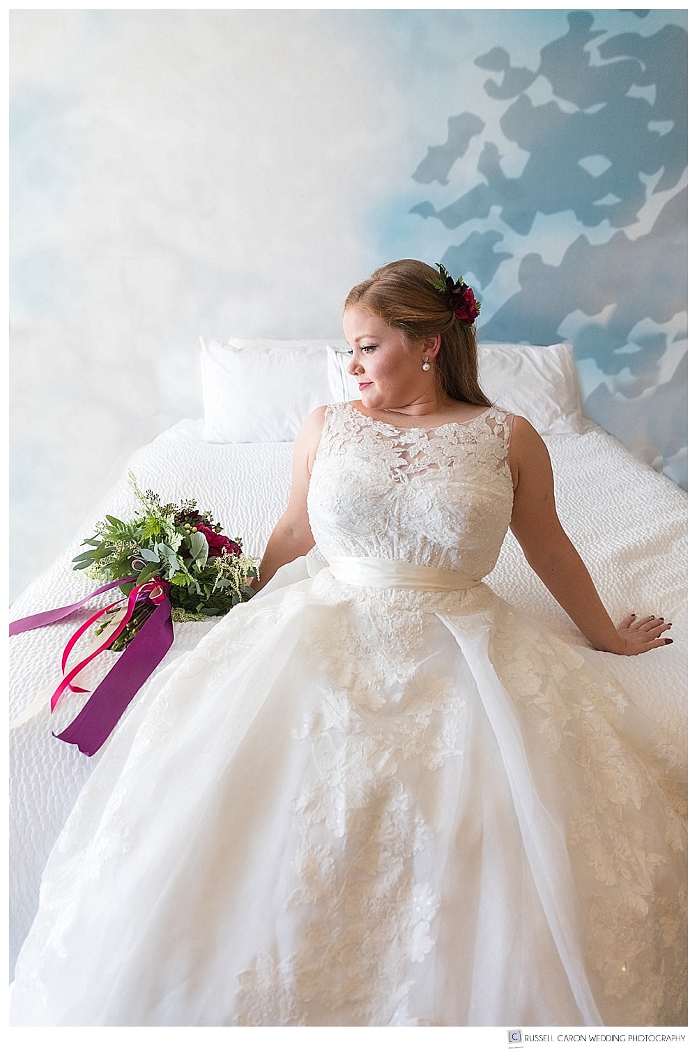 bride leaning back on bed
